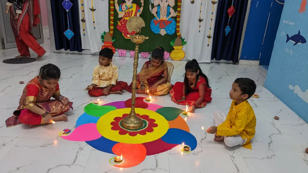 Our children lightening Diyas over rangoli